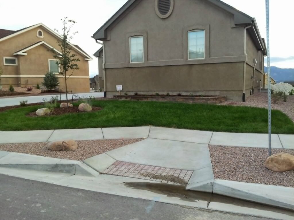 Front yard transformation from unfinished dirt to polished xeriscape with plants and rock

