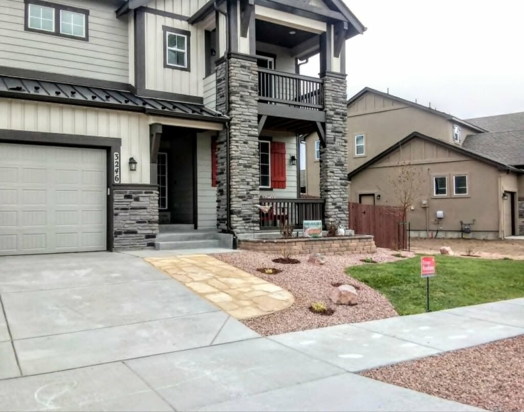 Front yard transformation from unfinished dirt to polished xeriscape with plants and rock

