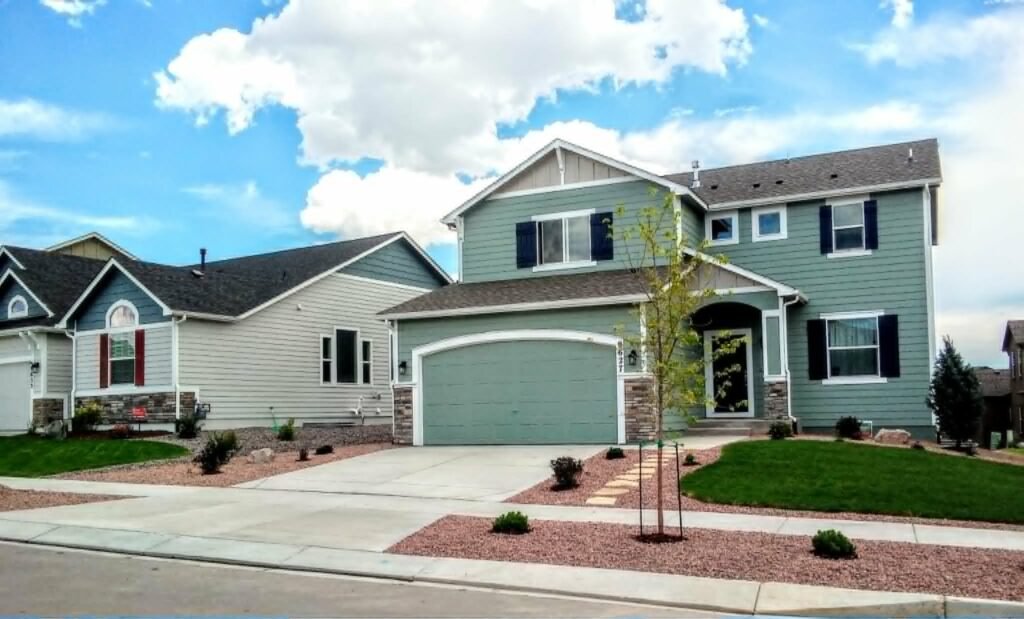 Front yard transformation from unfinished dirt to polished xeriscape with plants and rock

