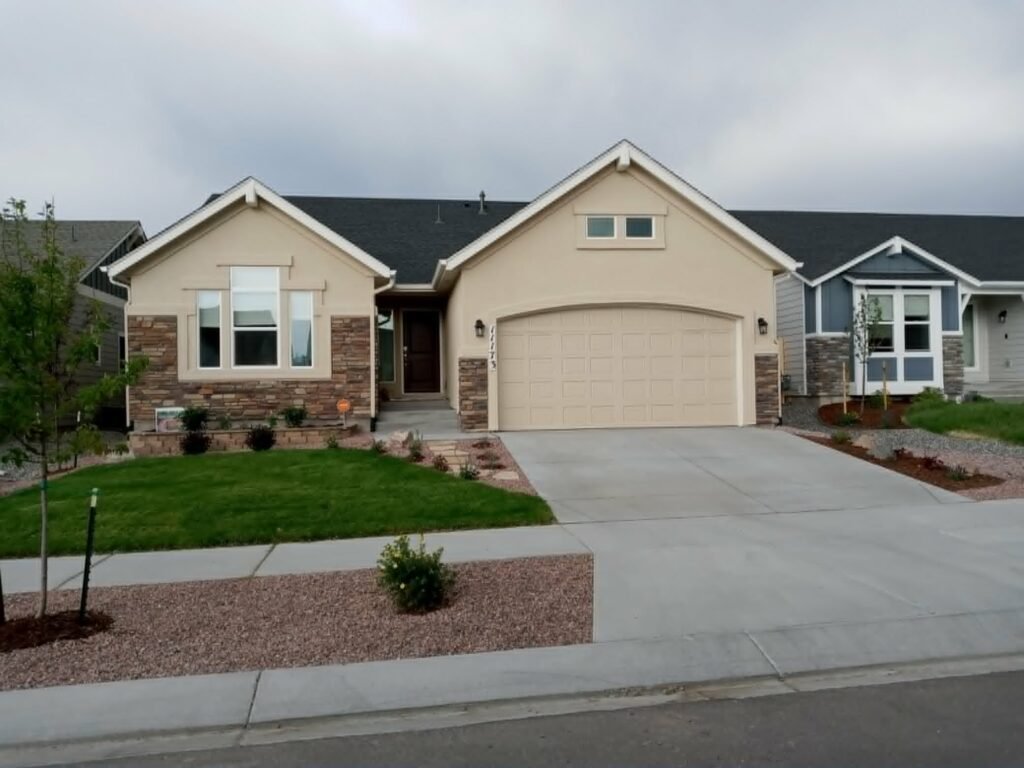 Front yard transformation from unfinished dirt to polished xeriscape with plants and rock

