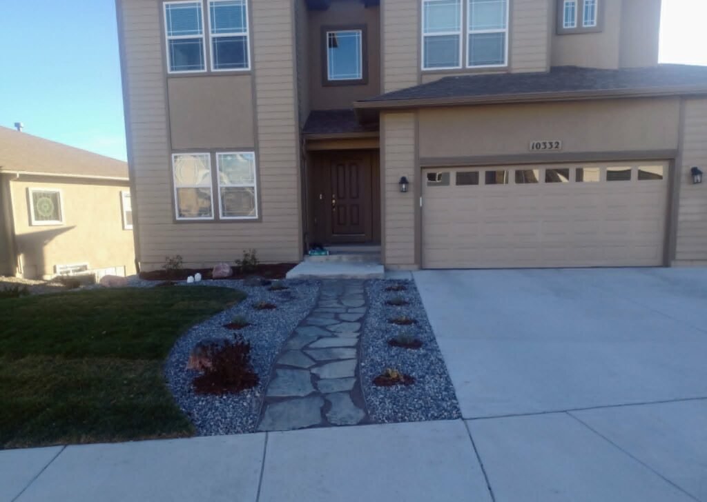 Front yard transformation from unfinished dirt to polished xeriscape with plants and rock

