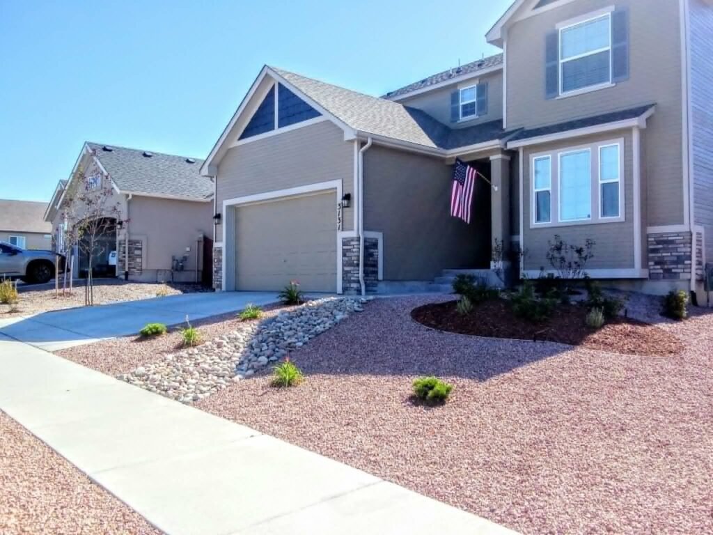 Water-wise xeriscape front yard featuring native shrubs, mulch, and drip irrigation

