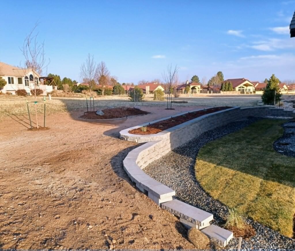 Concrete block retaining wall stabilizing a sloped backyard in Colorado Springs

