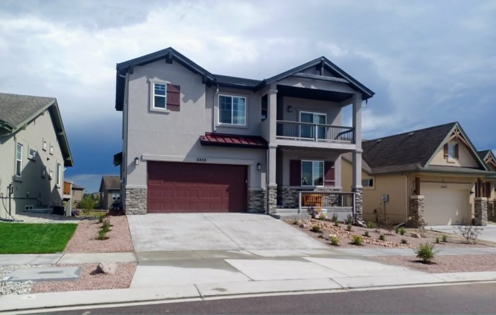 Front yard transformation from unfinished dirt to polished xeriscape with plants and rock

