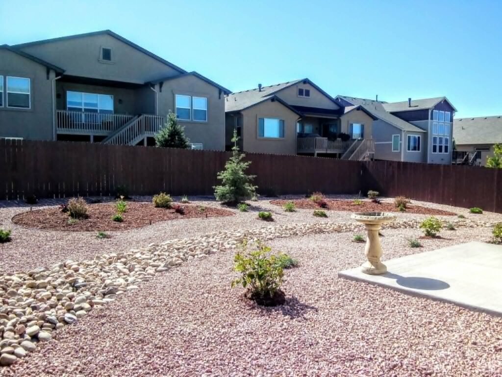 Water-wise xeriscape front yard featuring native shrubs, mulch, and drip irrigation

