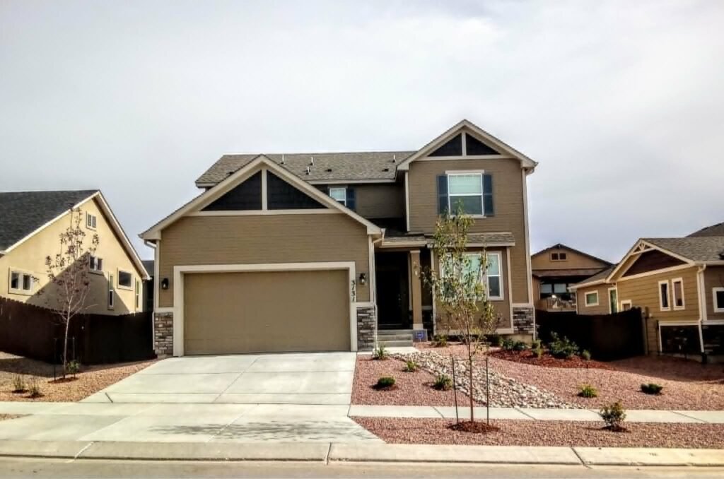 Front yard transformation from unfinished dirt to polished xeriscape with plants and rock

