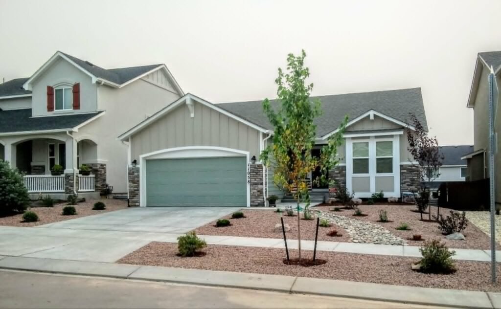 Front yard transformation from unfinished dirt to polished xeriscape with plants and rock

