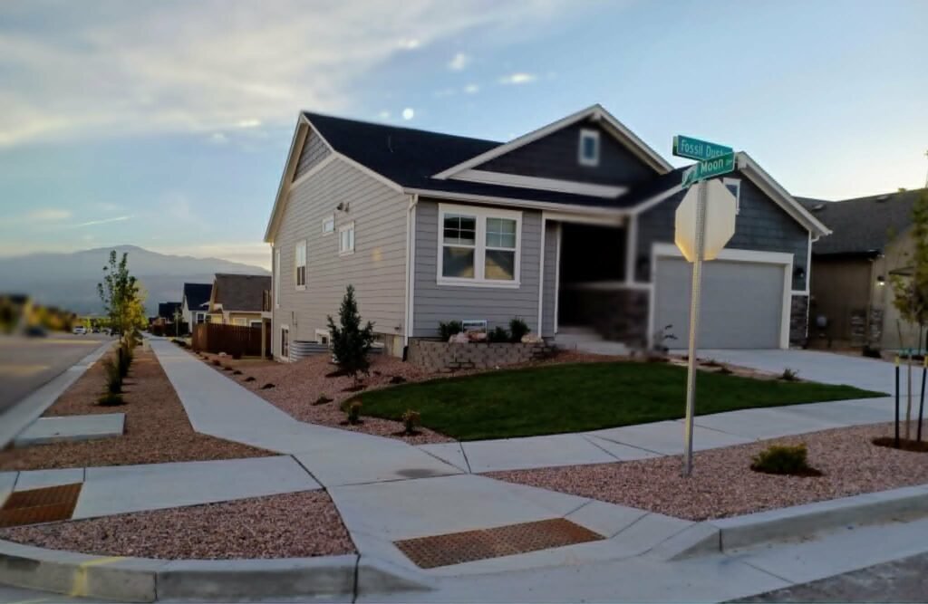 Water-wise xeriscape front yard featuring native shrubs, mulch, and drip irrigation

