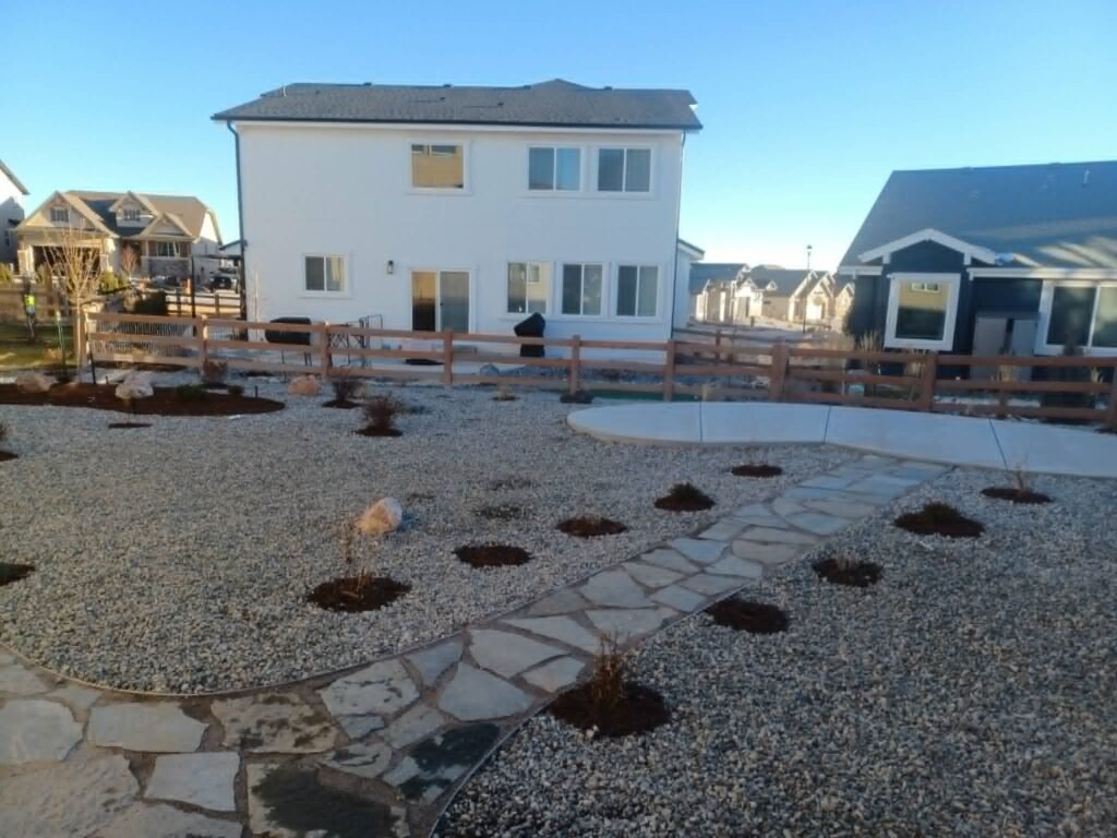 Water-wise xeriscape front yard featuring native shrubs, mulch, and drip irrigation

