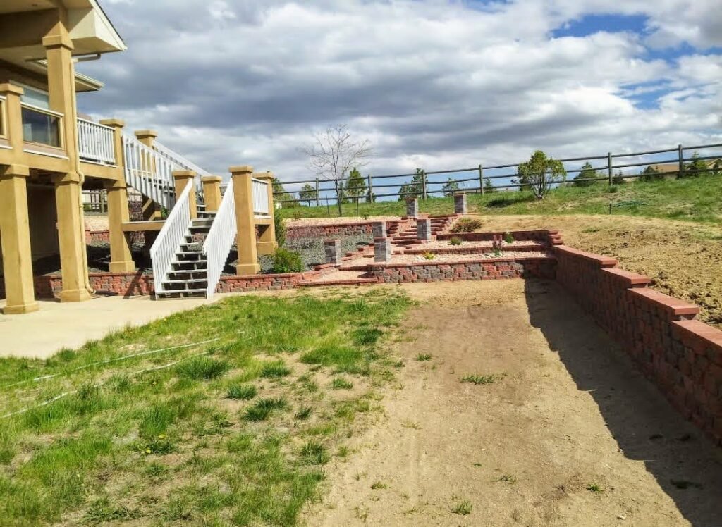 Concrete block retaining wall stabilizing a sloped backyard in Colorado Springs

