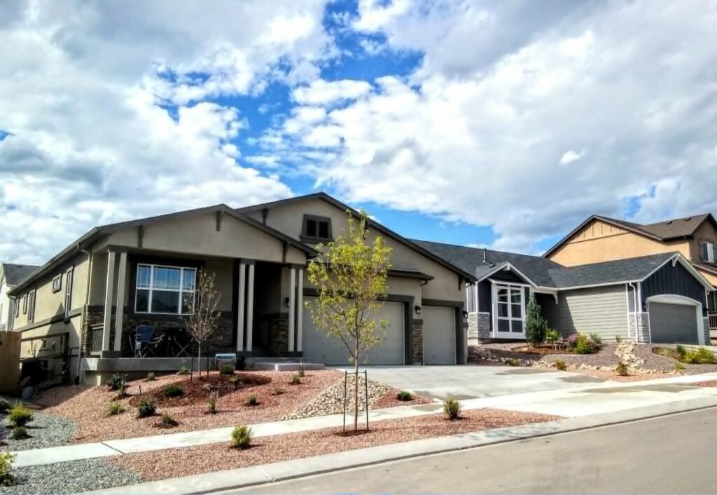 Front yard transformation from unfinished dirt to polished xeriscape with plants and rock

