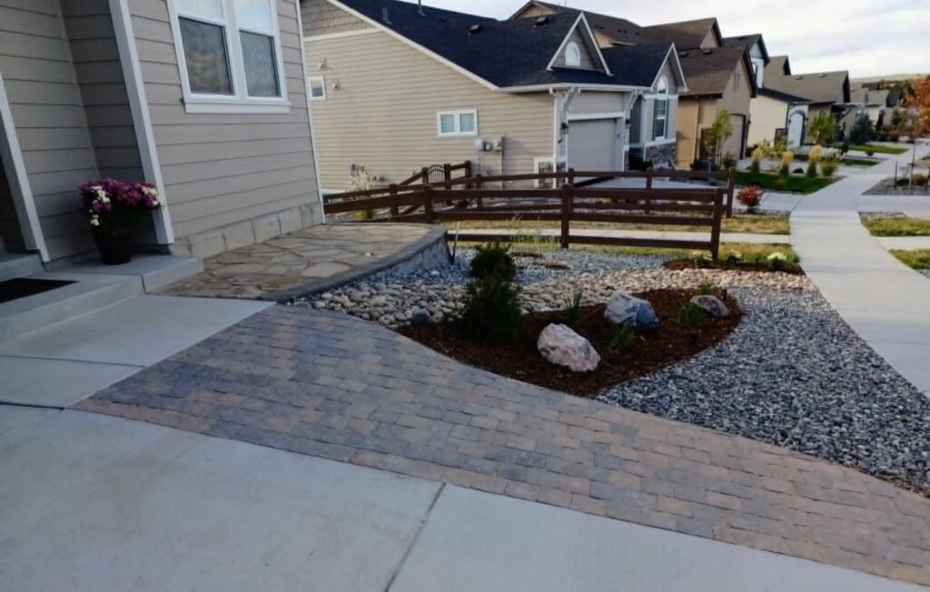 Water-wise xeriscape front yard featuring native shrubs, mulch, and drip irrigation

