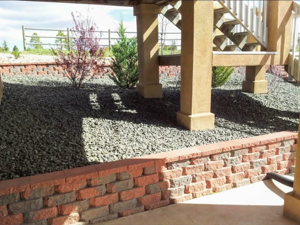Concrete block retaining wall stabilizing a sloped backyard in Colorado Springs

