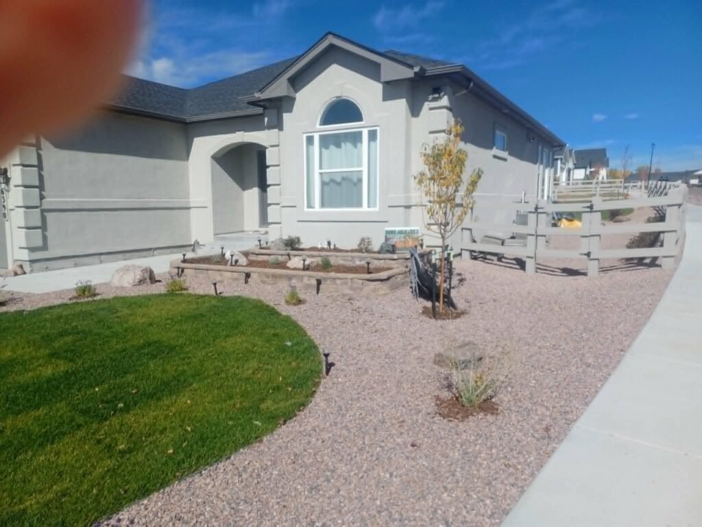 Front yard transformation from unfinished dirt to polished xeriscape with plants and rock

