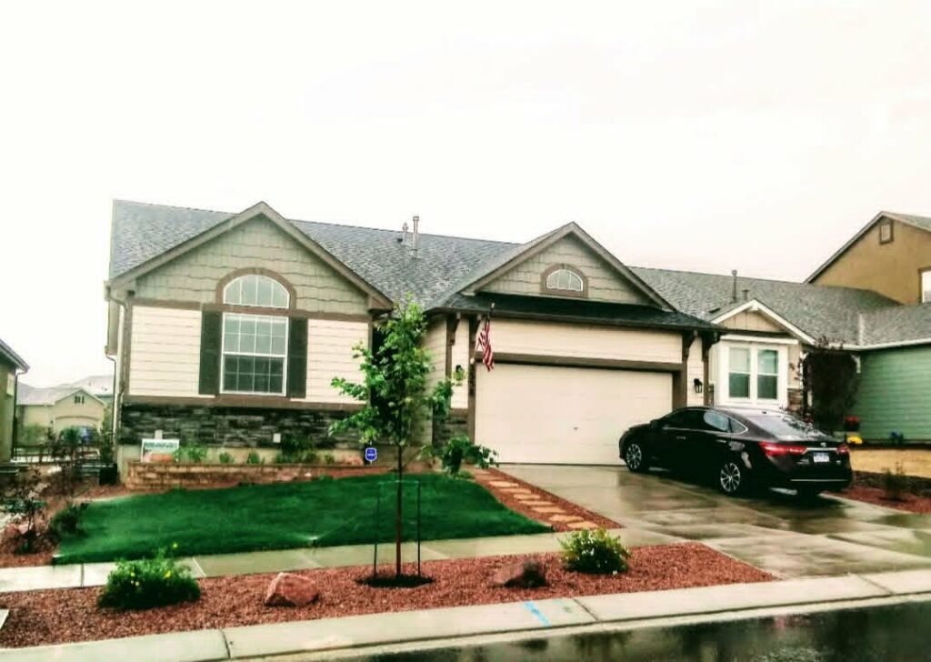 Front yard transformation from unfinished dirt to polished xeriscape with plants and rock

