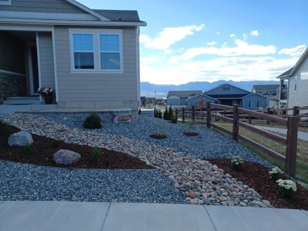 Water-wise xeriscape front yard featuring native shrubs, mulch, and drip irrigation

