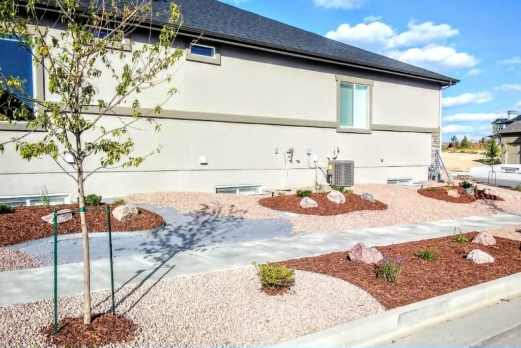 Water-wise xeriscape front yard featuring native shrubs, mulch, and drip irrigation

