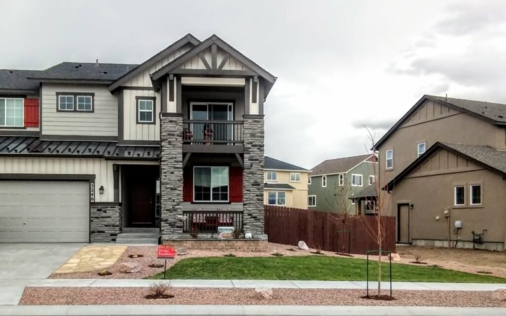 Front yard transformation from unfinished dirt to polished xeriscape with plants and rock

