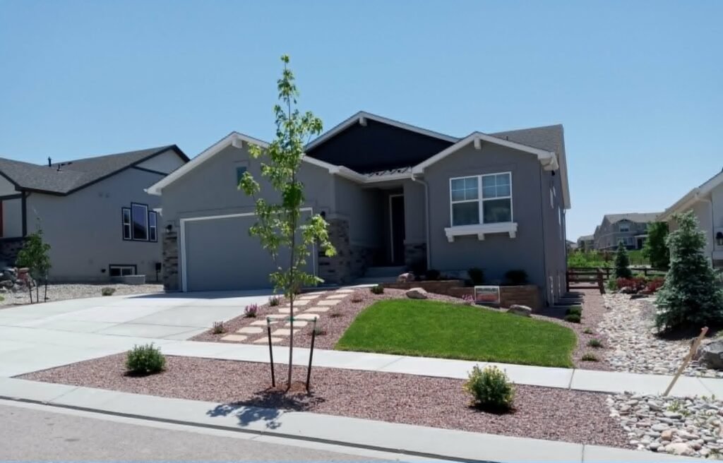 Front yard transformation from unfinished dirt to polished xeriscape with plants and rock

