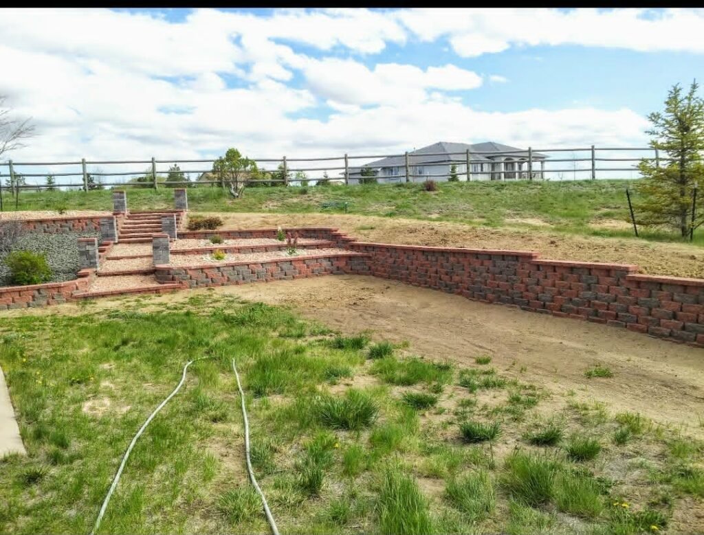 Concrete block retaining wall stabilizing a sloped backyard in Colorado Springs

