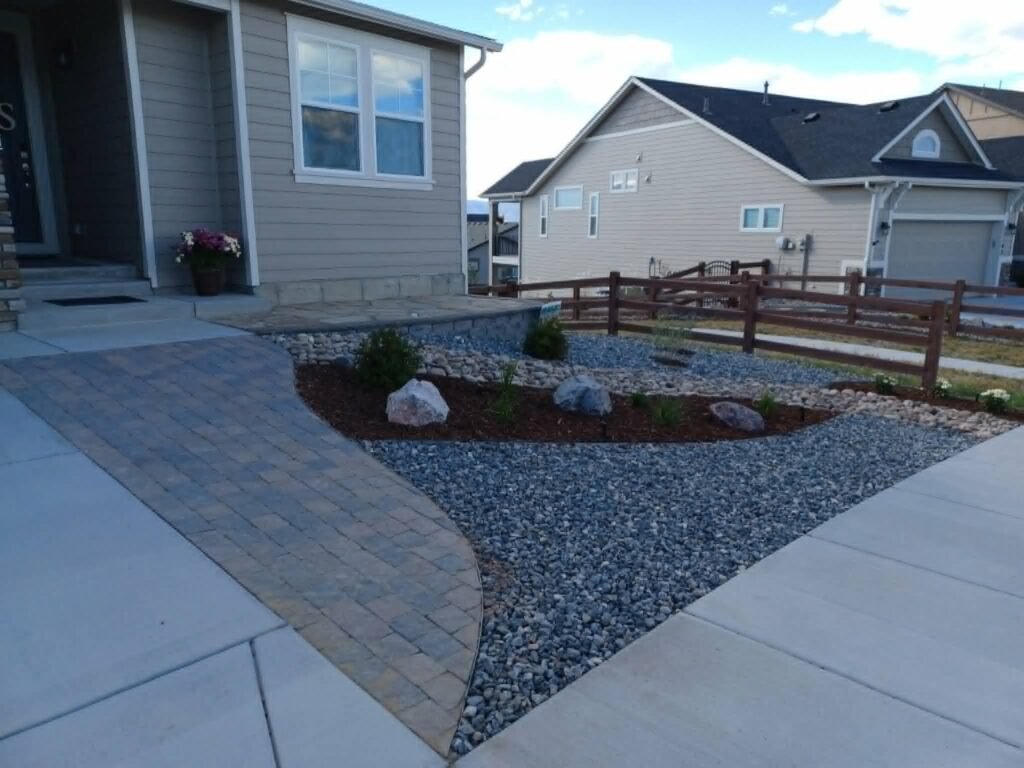 Water-wise xeriscape front yard featuring native shrubs, mulch, and drip irrigation

