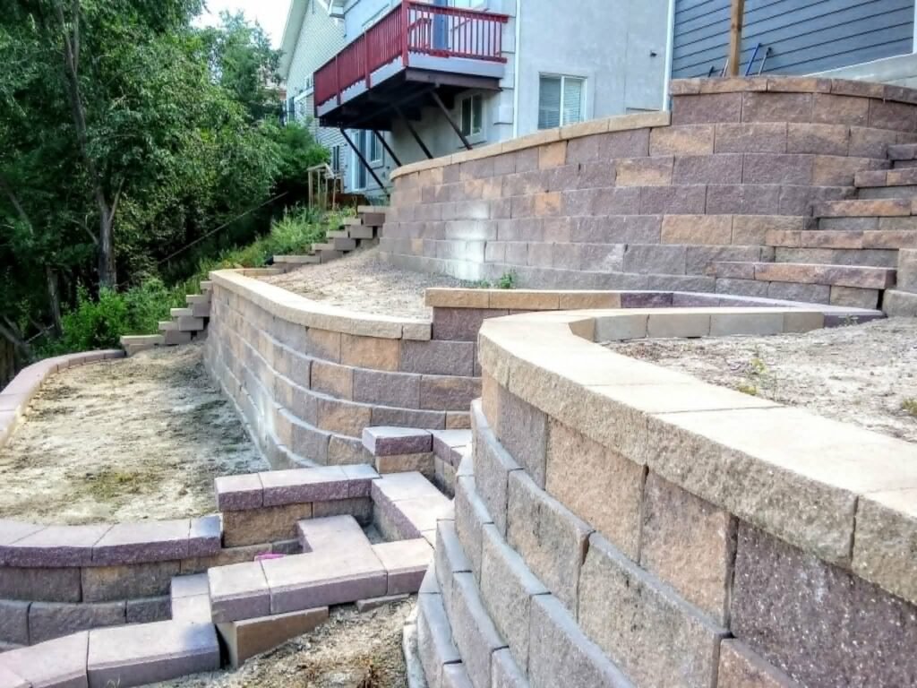 Concrete block retaining wall stabilizing a sloped backyard in Colorado Springs

