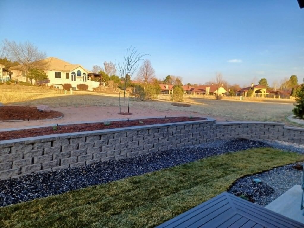 Concrete block retaining wall stabilizing a sloped backyard in Colorado Springs

