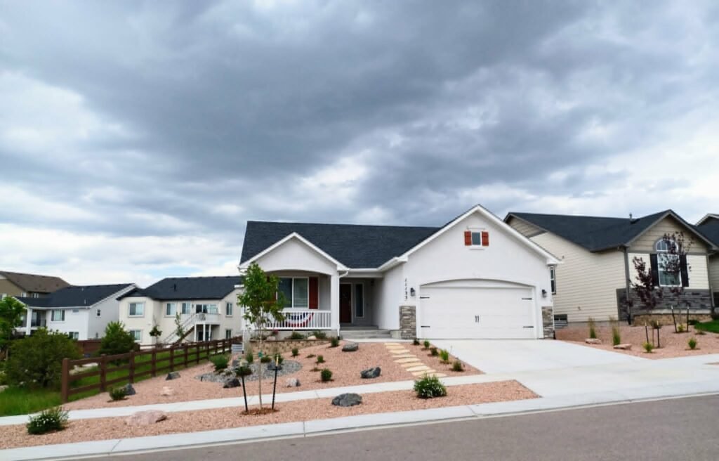 Front yard transformation from unfinished dirt to polished xeriscape with plants and rock

