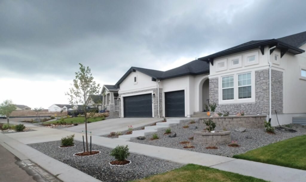 Front yard transformation from unfinished dirt to polished xeriscape with plants and rock

