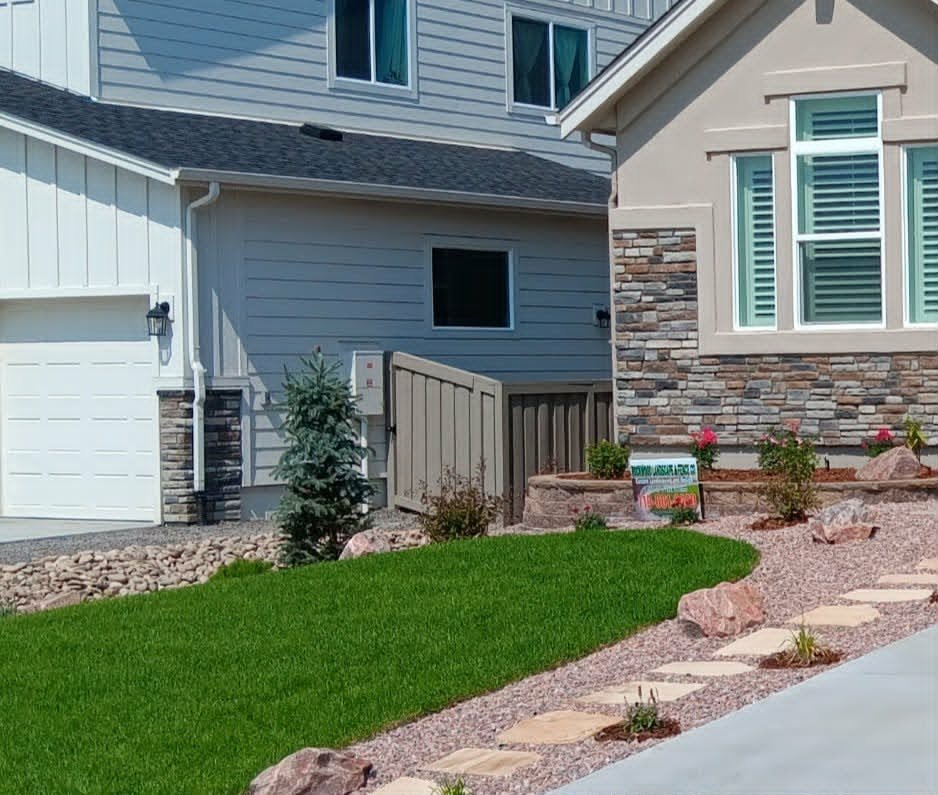 Front yard transformation from unfinished dirt to polished xeriscape with plants and rock

