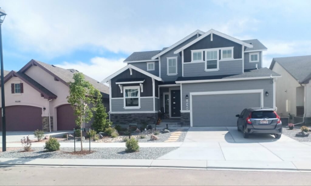 Front yard transformation from unfinished dirt to polished xeriscape with plants and rock

