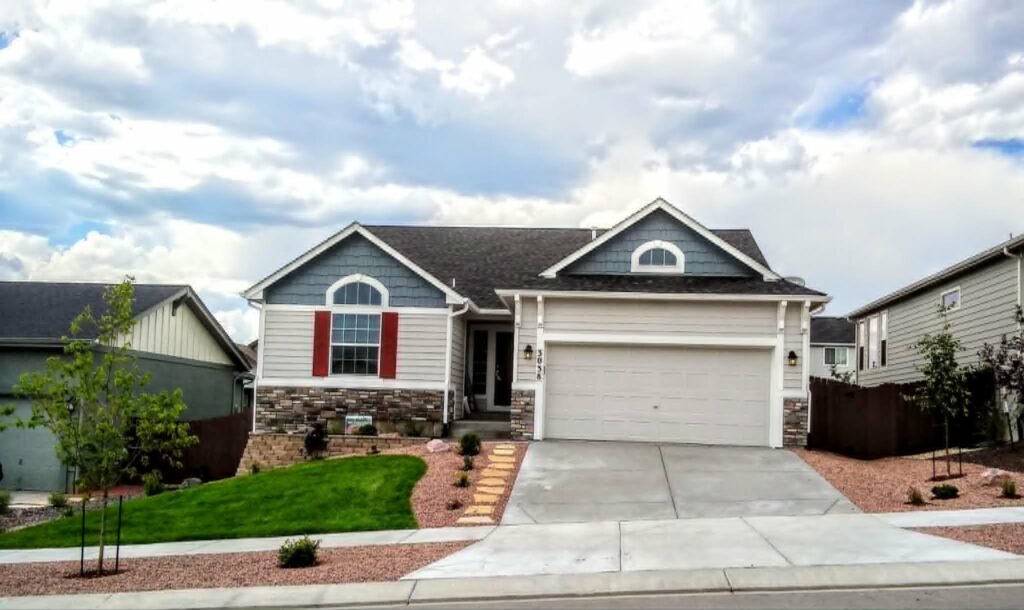 Front yard transformation from unfinished dirt to polished xeriscape with plants and rock

