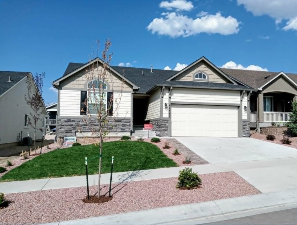 Front yard transformation from unfinished dirt to polished xeriscape with plants and rock

