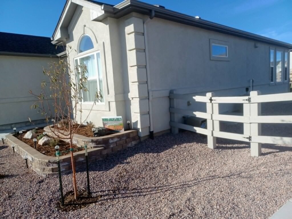Segmental block retaining wall with drainage gravel and landscape lighting

