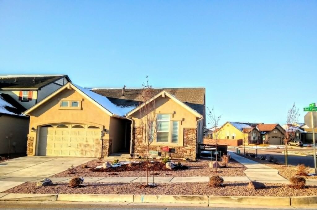 Front yard transformation from unfinished dirt to polished xeriscape with plants and rock

