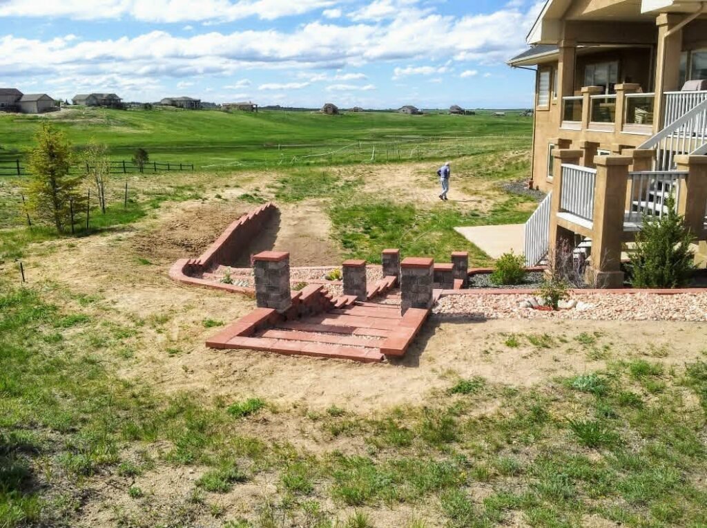 Concrete block retaining wall stabilizing a sloped backyard in Colorado Springs

