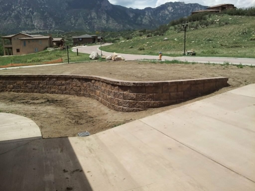 Concrete block retaining wall stabilizing a sloped backyard in Colorado Springs

