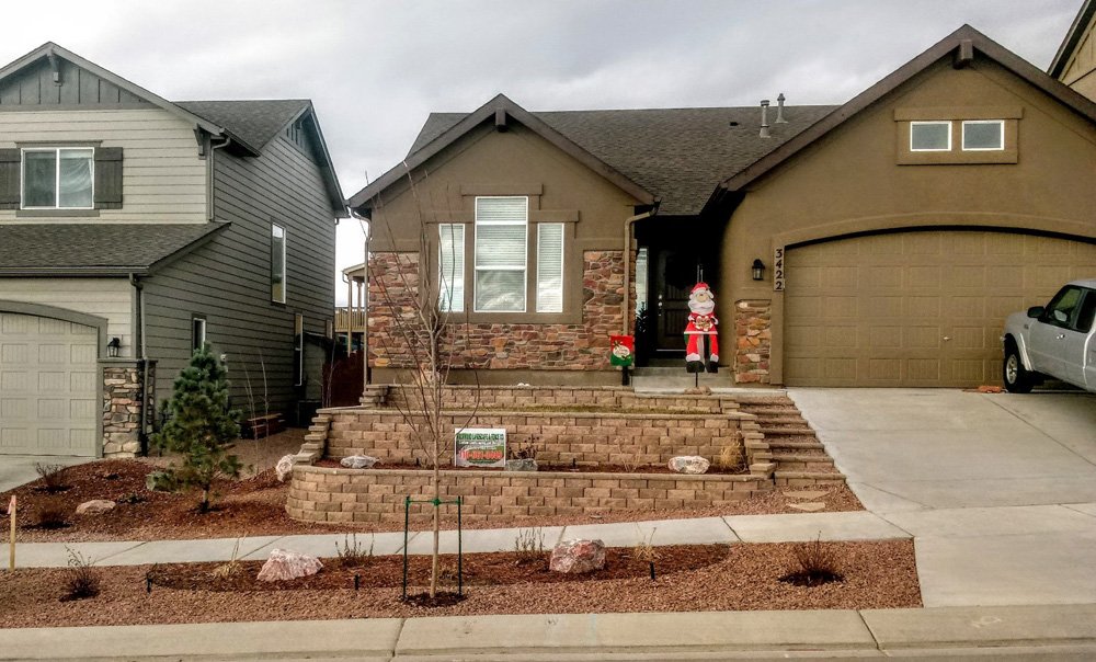 Front yard transformation from unfinished dirt to polished xeriscape with plants and rock

